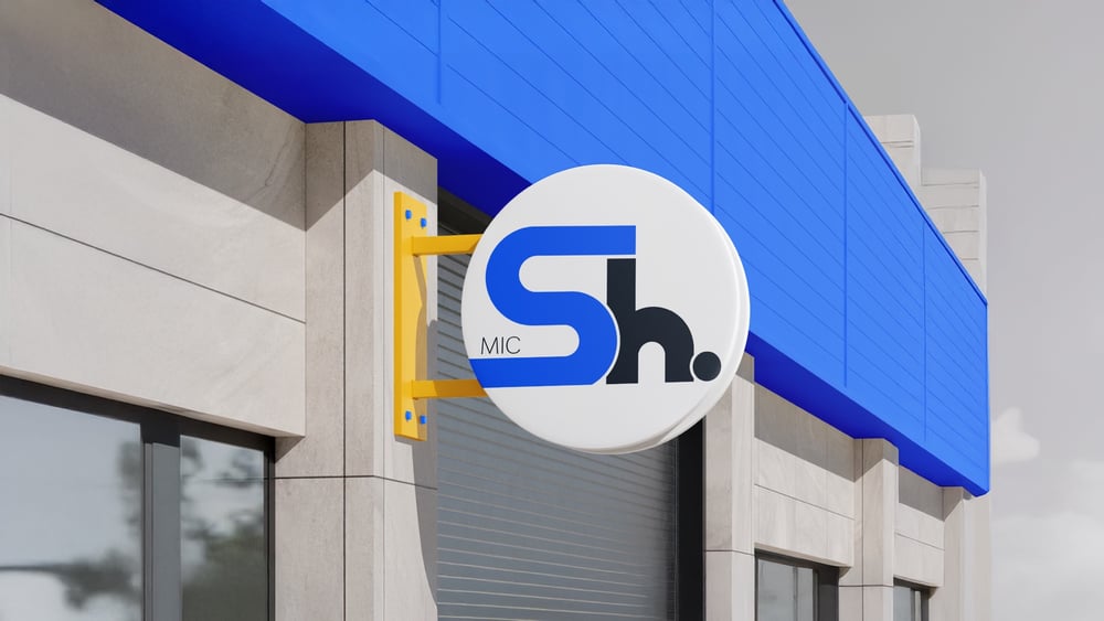 Shield secondary logo on a round outdoor blade sign with yellow bracket